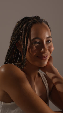 Studio-Beauty-Shot-Of-Smiling-Young-Woman-With-Long-Braided-Hair-Against-Neutral-Background-2